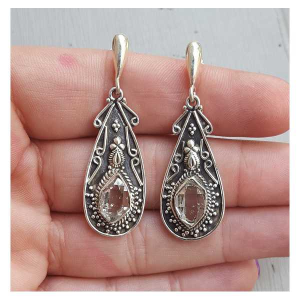 Silver earrings set with Herkimer Diamonds in a carved setting