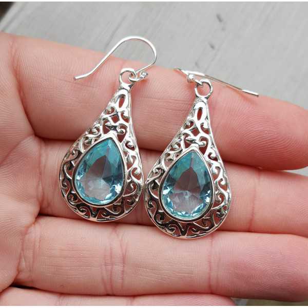 Silver earrings with blue Topaz in open worked setting 