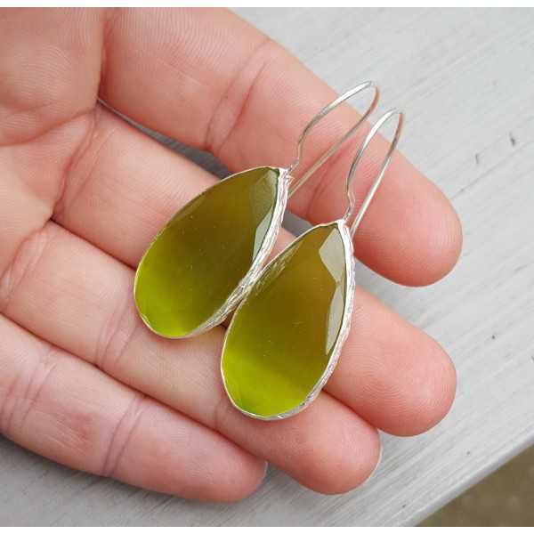 Silver earrings set with small oval green cats eye