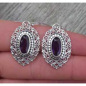 Silver earrings with oval faceted Amethyst in carved setting 