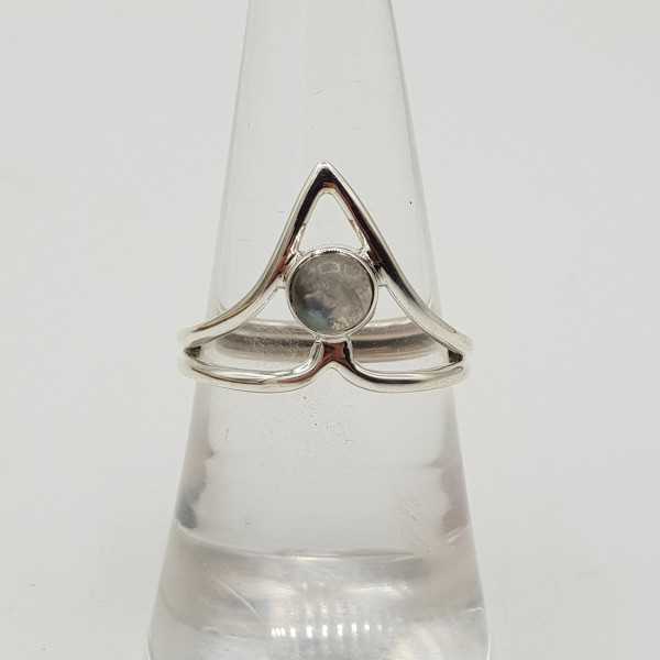 Silver ring with a small round cabochon Moonstone