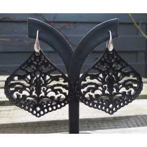 Silver earrings set with carved black buffalo horn