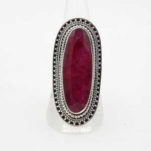 A silver ring set with a large oval shaped Ruby