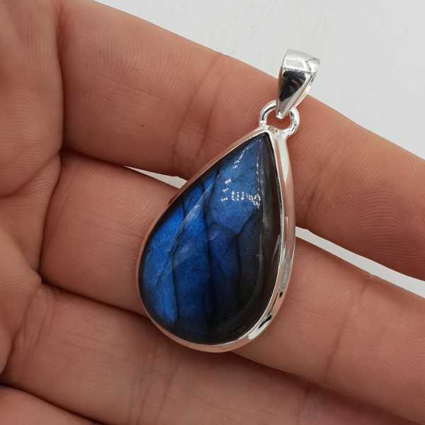 A silver pendant with a cabochon cut Labradorite