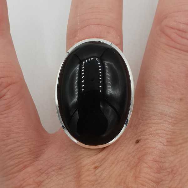 A silver ring with a large oval-shaped black Onyx 17 mm