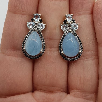 Silver earrings with aquamarine blue topaz and black spinning