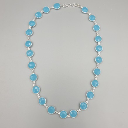 Silver necklace rounded around with round facet blue chalcedone