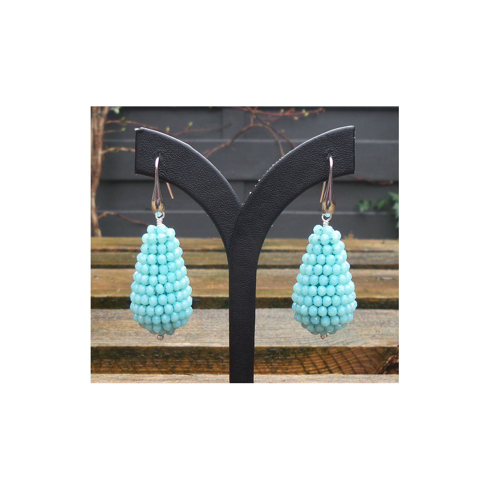 Silver earrings with large drop of light blue crystals