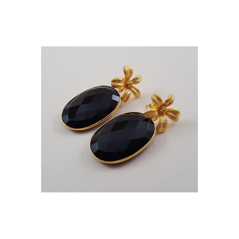 Gold gilded earrings set with oval facet black onyx