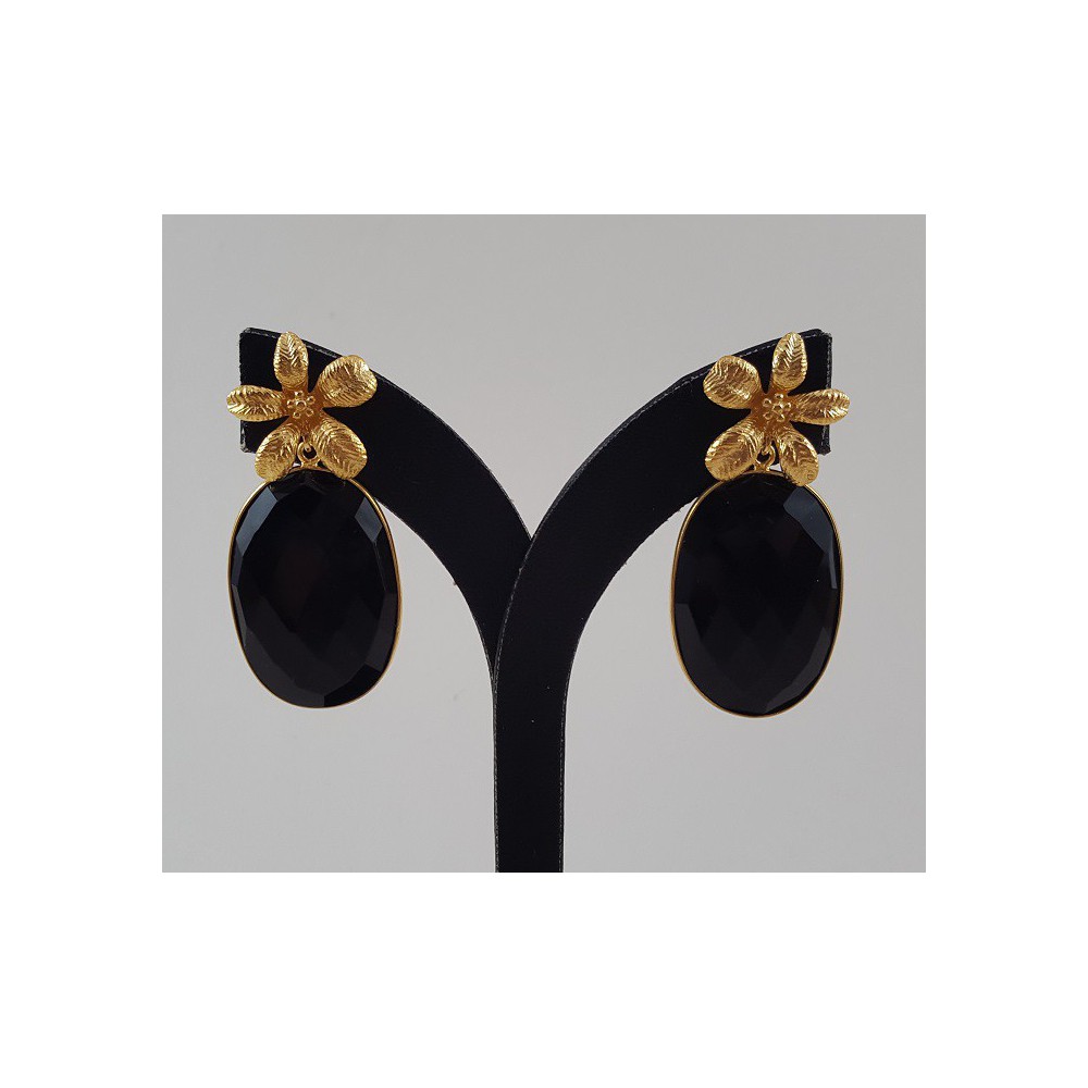 Gold gilded earrings set with oval facet black onyx