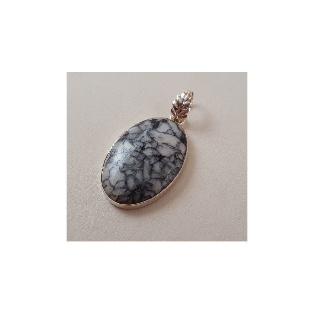 Silver pendant set with oval pinolite