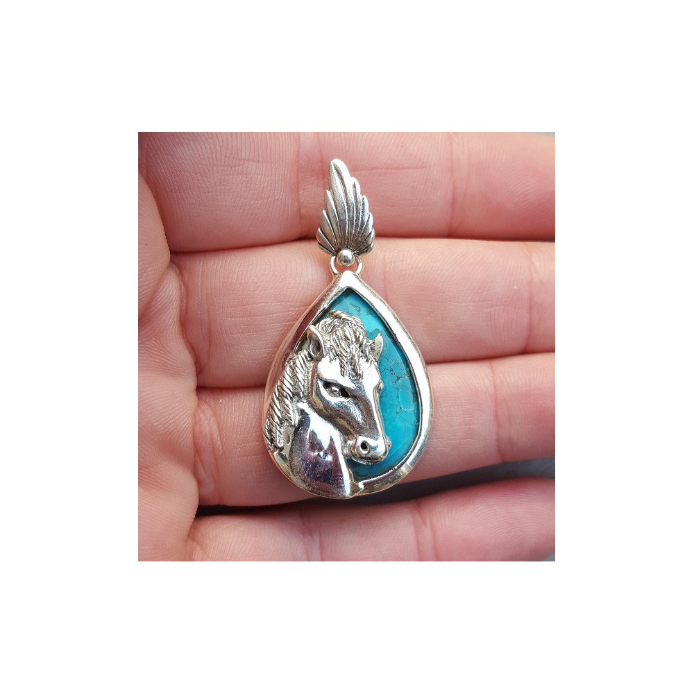 Silver pendant set with turquoise and silver horse head