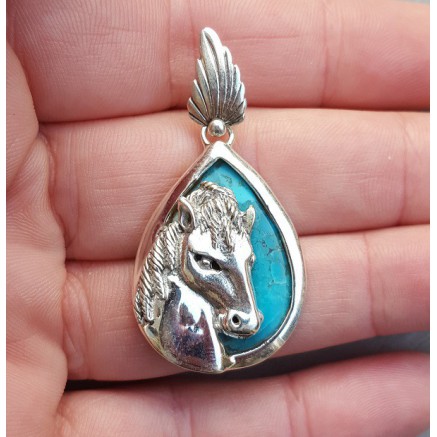 Silver pendant set with turquoise and silver horse head