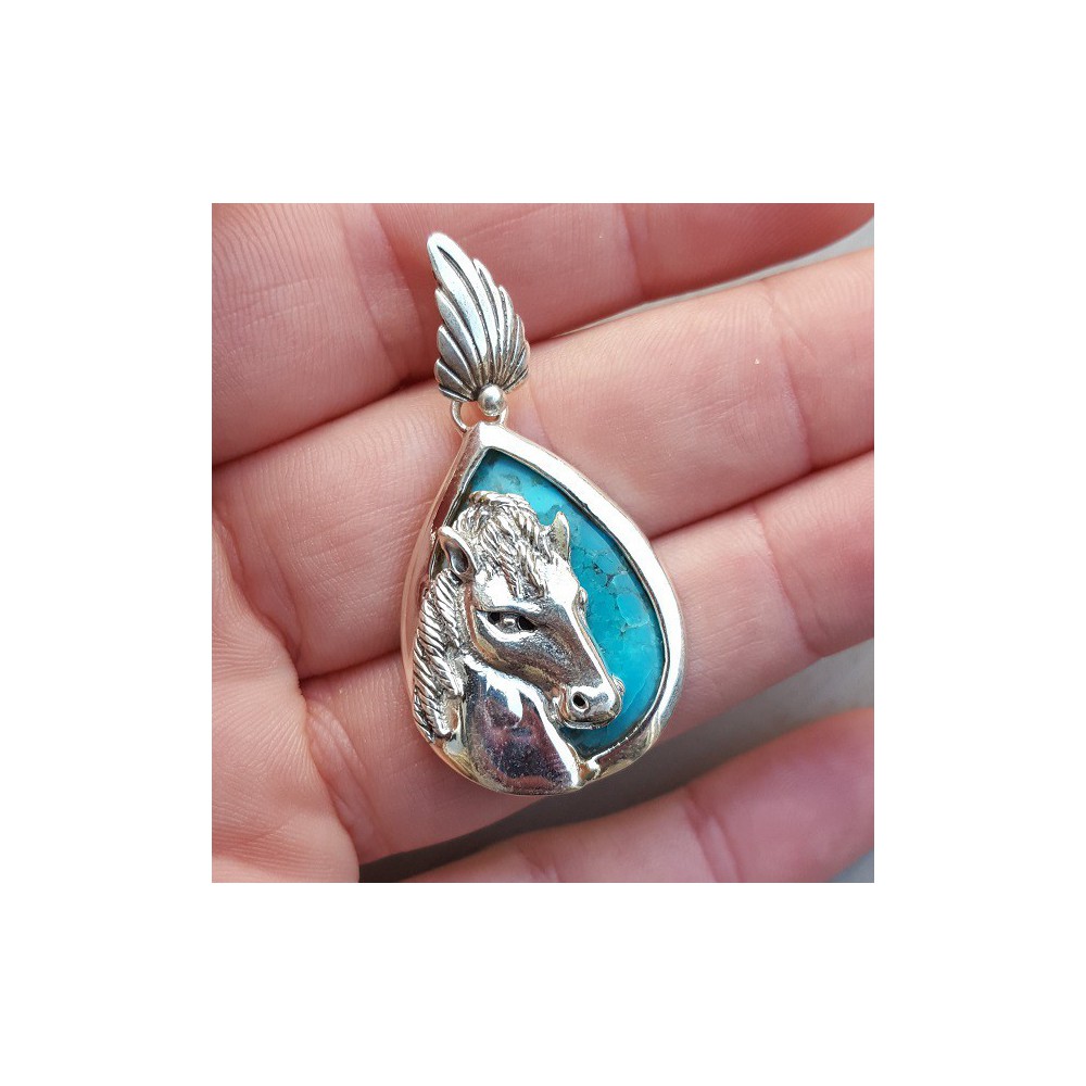 Silver pendant set with turquoise and silver horse head