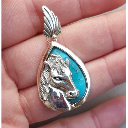 Silver pendant set with turquoise and silver horse head