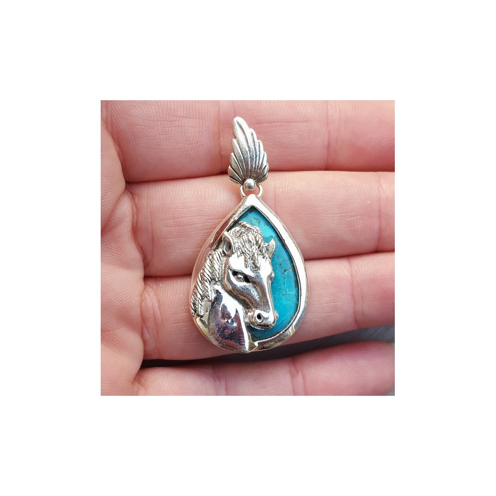 Silver pendant set with turquoise and silver horse head