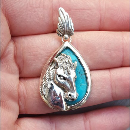 Silver pendant set with turquoise and silver horse head