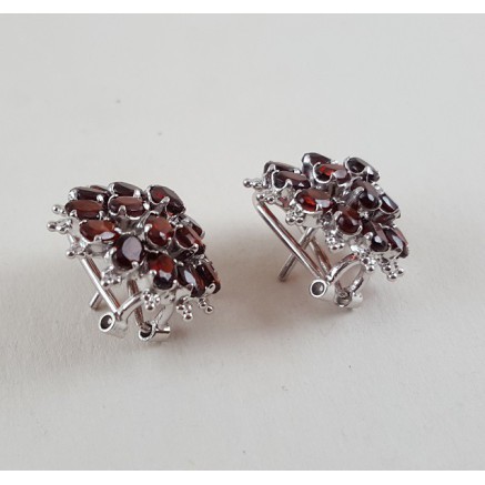 Silver earrings set with oval facet cut grenades