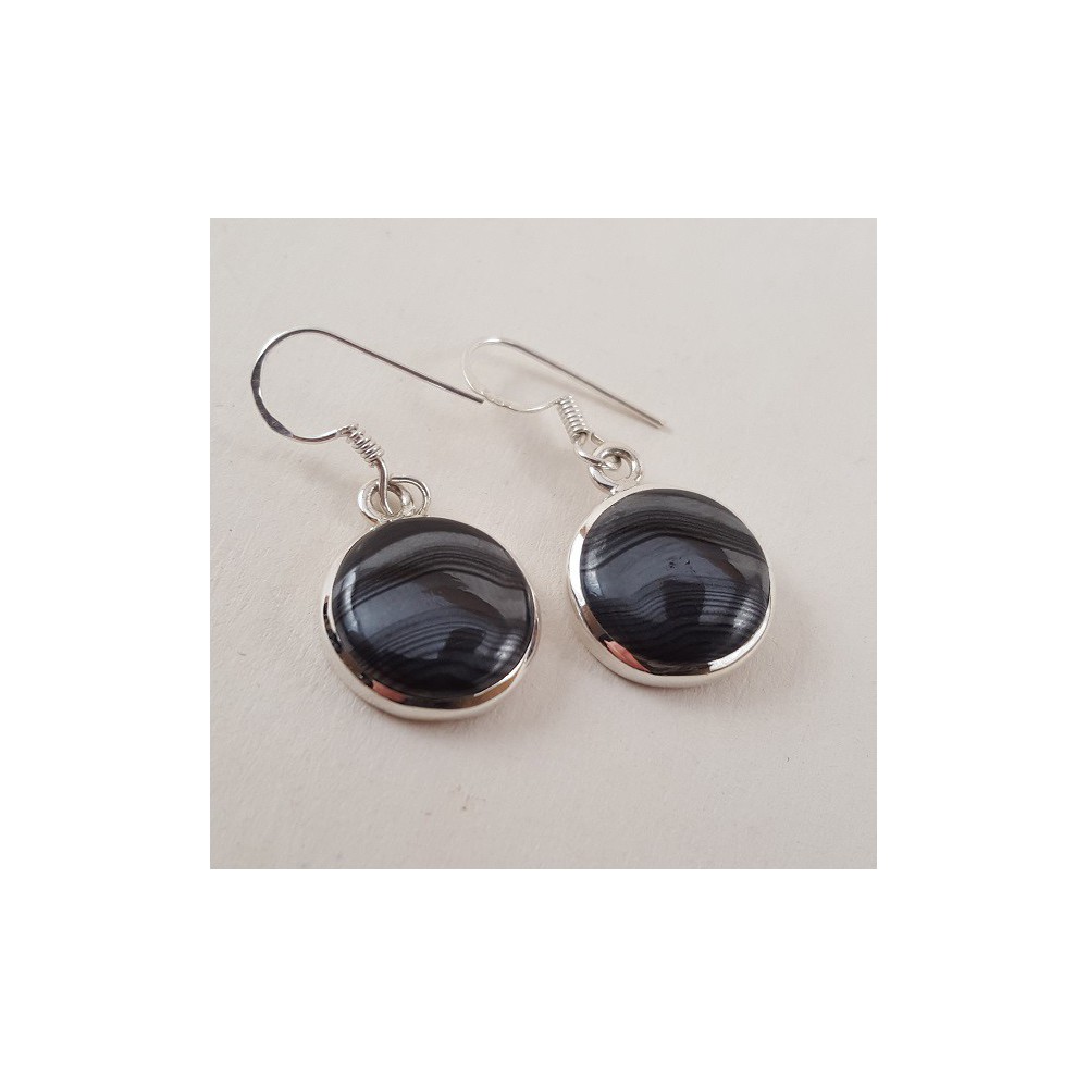 Silver earrings set with round psilomelaan