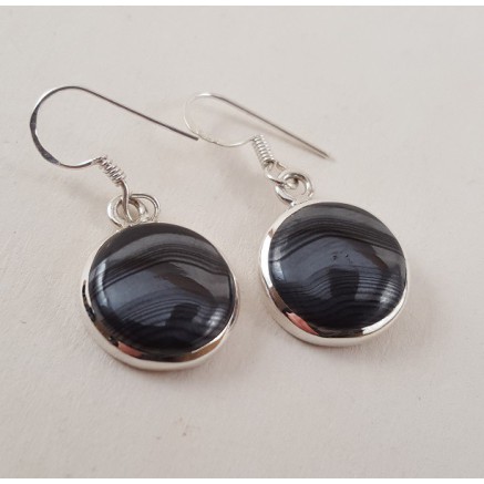 Silver earrings set with round psilomelaan