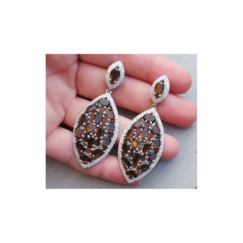 Silver earrings set with oval smokey topazen and zirconia