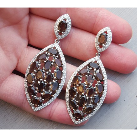 Silver earrings set with oval smokey topazen and zirconia