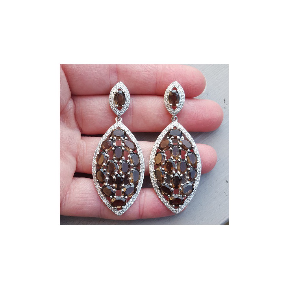 Silver earrings set with oval smokey topazen and zirconia