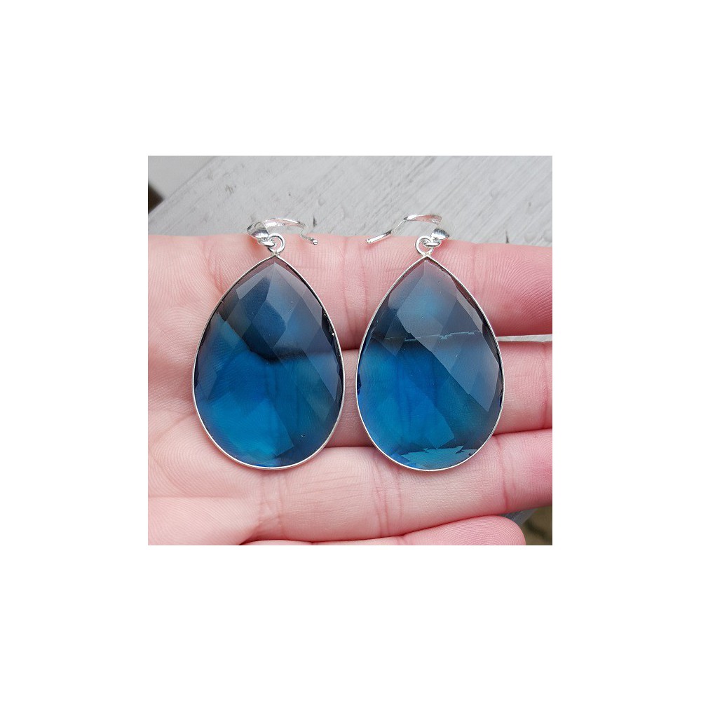 Silver earrings set with large blue topaz quartz