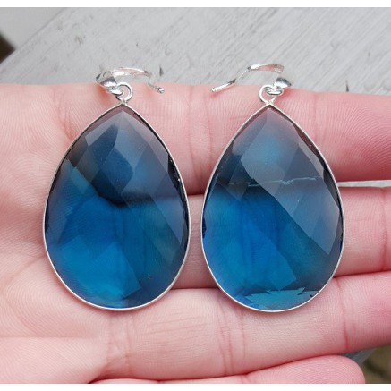 Silver earrings set with large blue topaz quartz