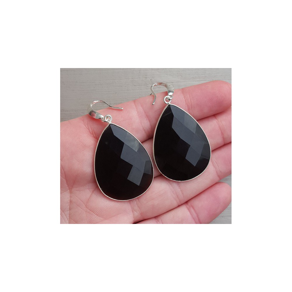 Silver earrings set with large black onyx