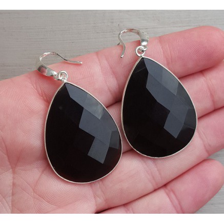 Silver earrings set with large black onyx