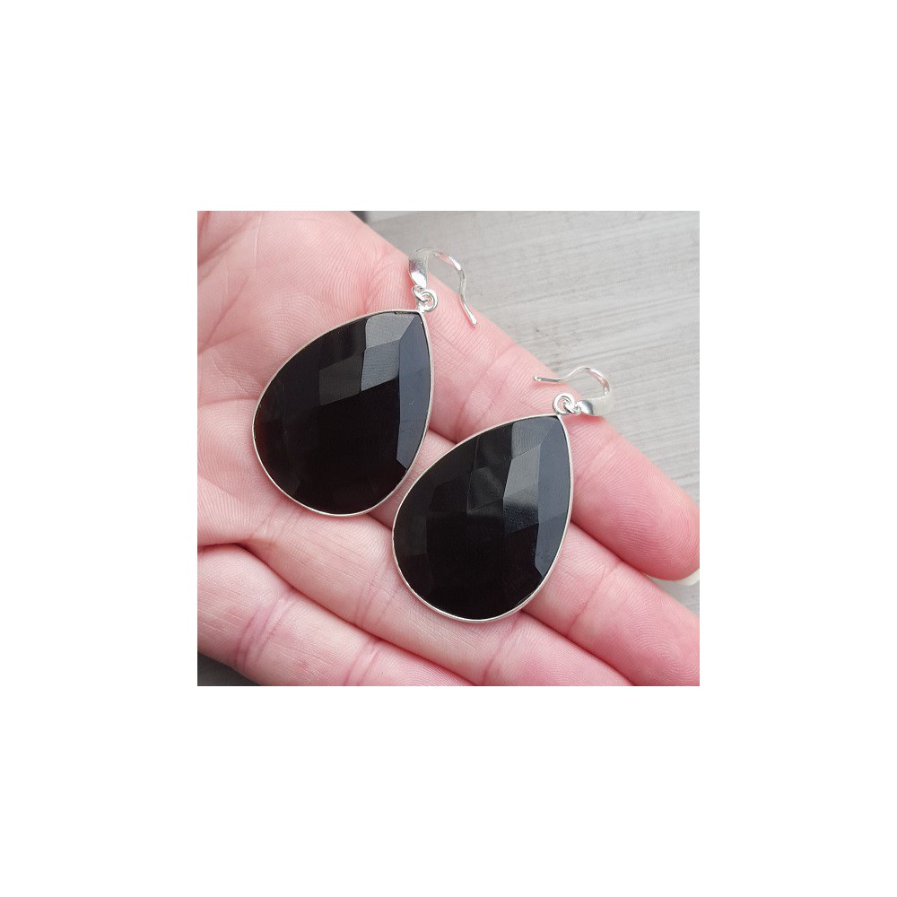 Silver earrings set with large black onyx