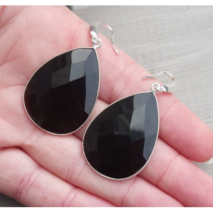 Silver earrings set with large black onyx