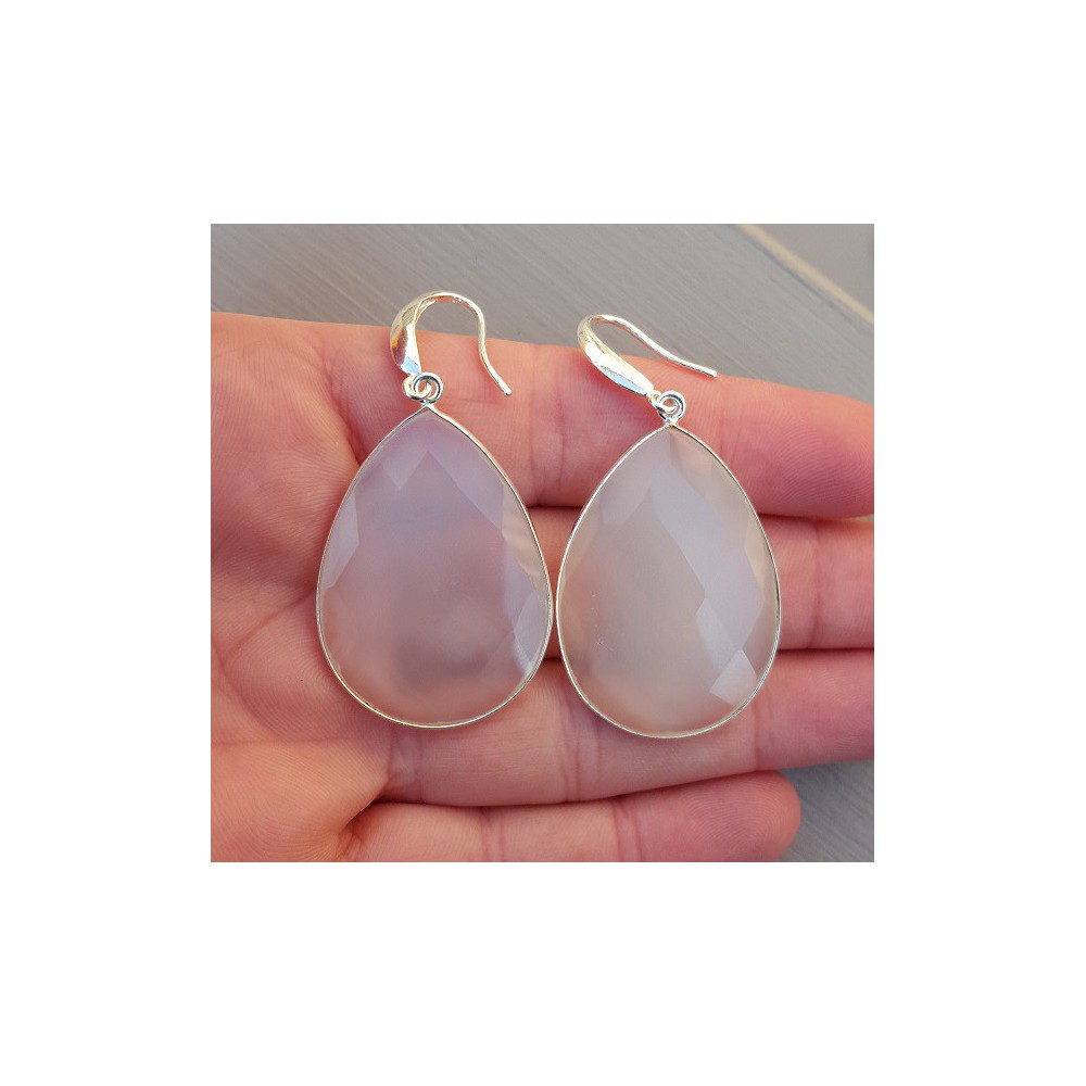 Silver earrings set with large white chalcedone