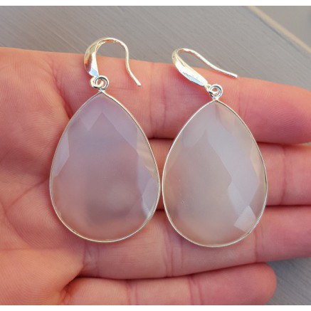 Silver earrings set with large white chalcedone