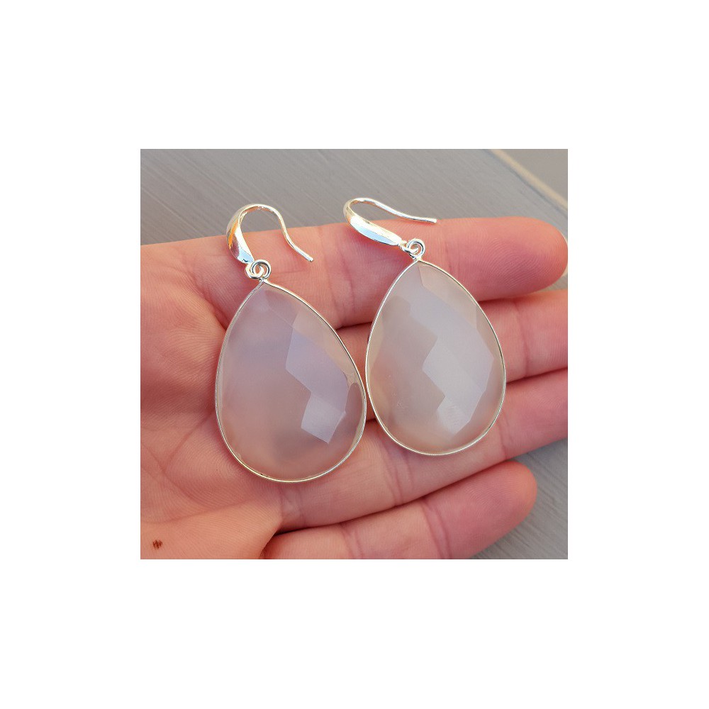 Silver earrings set with large white chalcedone