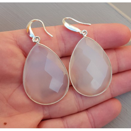 Silver earrings set with large white chalcedone