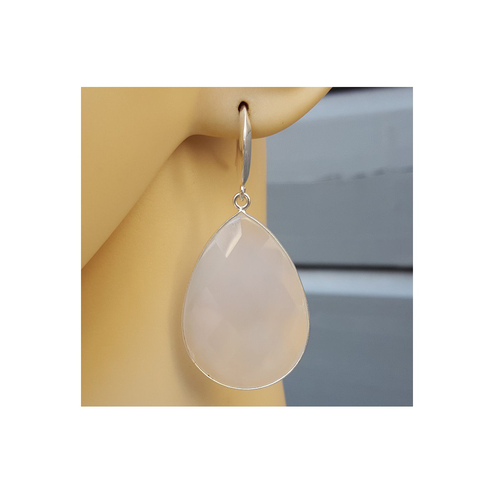 Silver earrings set with large white chalcedone