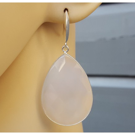 Silver earrings set with large white chalcedone